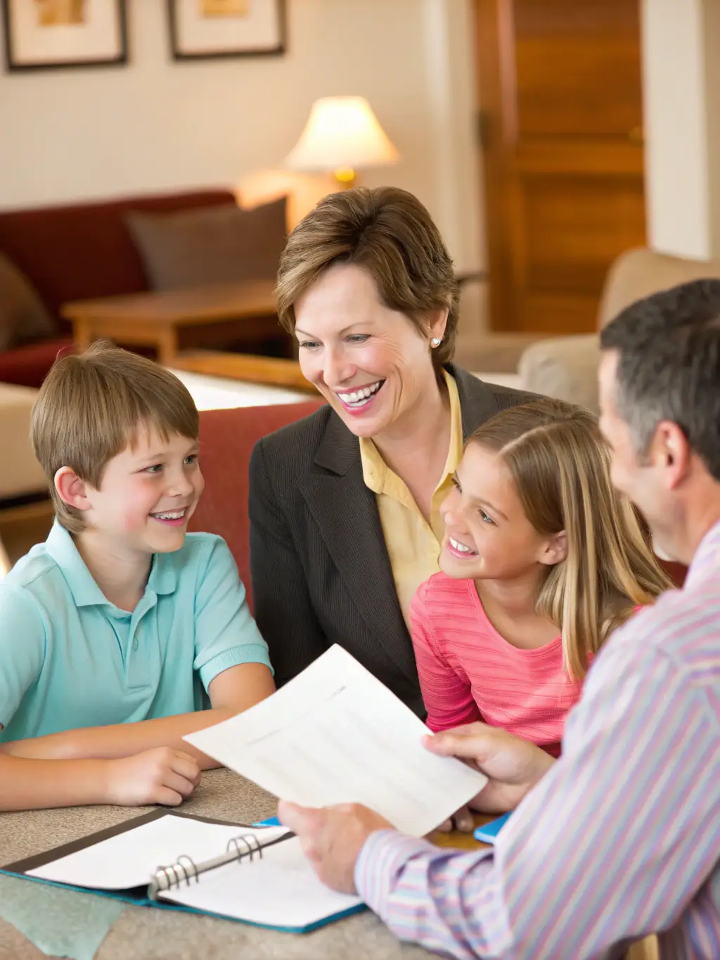 A Mexican family happily gathered around a table, discussing their financial future with a consultant.